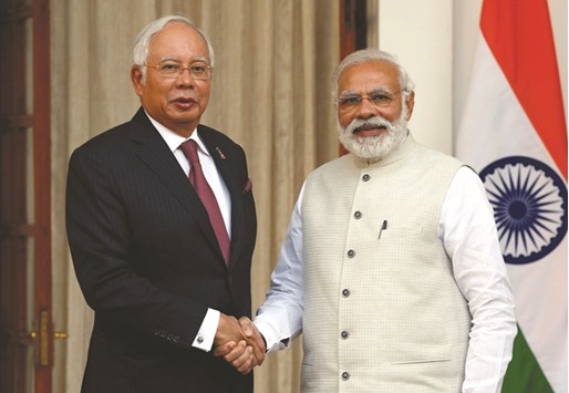 Malaysiau2019s Prime Minister Najib Razak shakes hands with his Indian counterpart Narendra Modi after meeting at Hyderabad House in New Delhi yesterday.