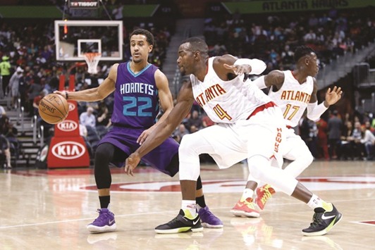 Charlotte Hornets guard Brian Roberts (No 22) is defended by Atlanta Hawks forward Paul Millsap (No 4) in the first quarter at Philips Arena. PICTURE: USA TODAY Sports