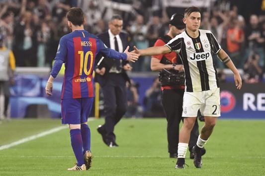 Juventusu2019 forward from Argentina Paulo Dybala (R) shakes hands with Barcelonau2019s Argentinian forward Lionel Messi at the end of the Champions League quarter-final first leg.