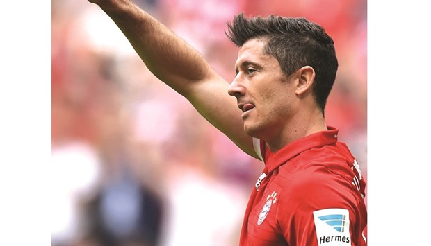 Bayern Munichu2019s Polish striker Robert Lewandowski celebrates after scoring his his third goal against Augusburg.