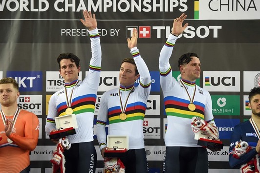 Gold medallists New Zealandu2019s Ethan Mitchell (C), Sam Webster (L) and Edward Dawkins (R), celebrate winning the menu2019s team sprint final at the Hong Kong Velodrome during the Track Cycling World Championships in Hong Kong yesterday. (AFP)