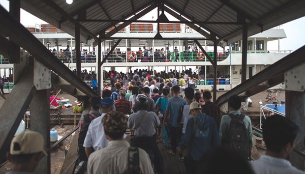 Passengers board a ferry in Yangon as they travel home to celebrate Thingyan, a water festival which brings in the countryu2019s New Year.