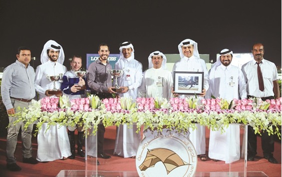 Qatar Racing and Equestrian Club (QREC) vice chief steward Abdulla Rashid al-Kubaisi with the winners of the Al Wukair Cup after Khalifa bin Sheail al-Kuwari-owned Muraqabah won the 1200m race at the QREC yesterday.  PICTURE: Juhaim