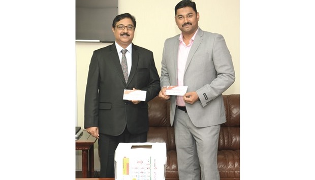 Ansari Haneefa (right) picked the winning coupons along with Sanjai Noah.