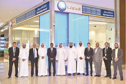 Officials of QIB Mall of Qatar branch.