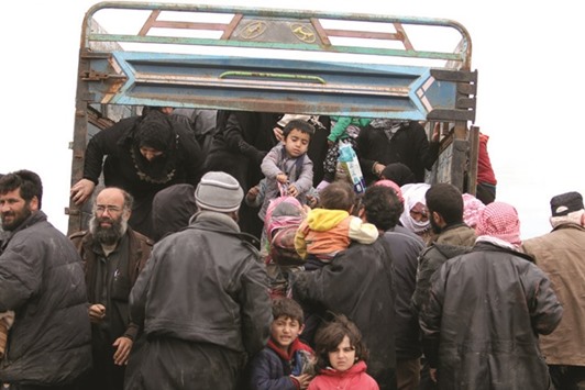 Internally displaced Syrian people who fled Raqqa city get out of a truck at a camp in Ain Issa, Raqqa Governorate, yesterday.
