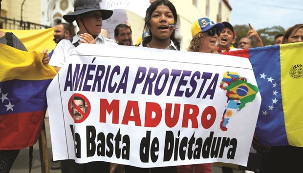 Venezuelans living in Peru and other protesters take part in a rally against President Nicolas Madurou2019s government outside the Venezuela embassy in Lima.