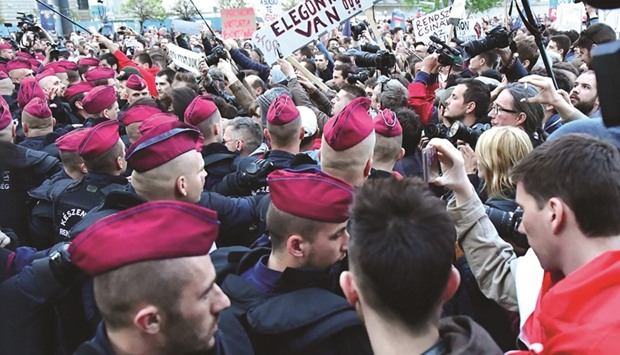 Police officers push protesters in front of the headquarters of Victor Orbanu2019s ruling Fidesz party in Budapest during a demonstration against higher education legislation.