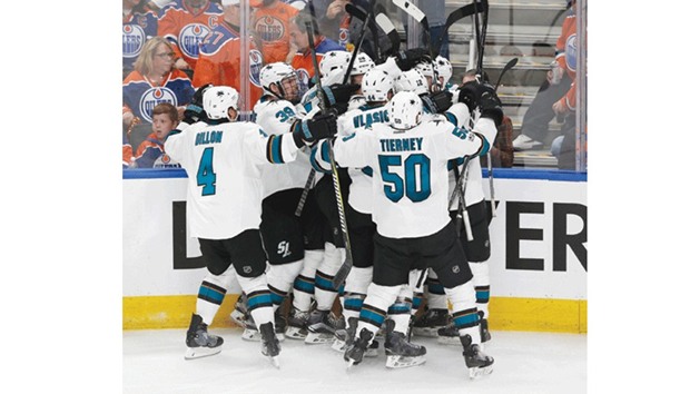 San Jose Sharks players celebrate an overtime winning goal by forward Melker Karlsson against the Edmonton Oilers in game one of the first round of the 2017 Stanley Cup Playoffs in Edmonton on Wednesday. (USA TODAY Sports)