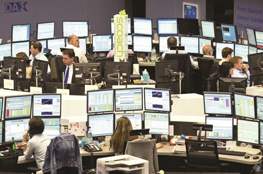 Brokers working at the stock exchange in Frankfurt. The DAX 30 was 0.4% down at 12,109.00 points yesterday.
