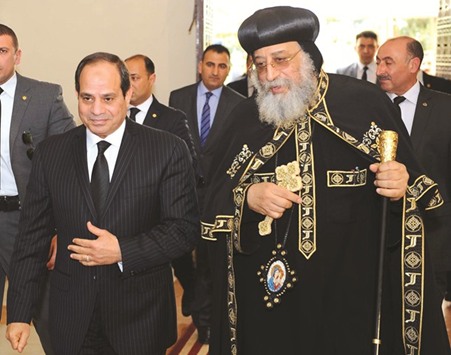 Egyptian President Abdel Fattah al-Sisi offers his condolences to Coptic Pope Tawadros II at the headquarters of St Marku2019s Coptic Orthodox Cathedral in the Abbasiyah suburb of Cairo.