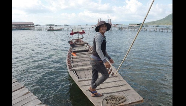A boatman prepares to take tourists out to a floating restaurant on a bay in Phu Quoc island in Southern Vietnam.