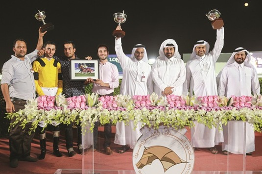 Qatar Racing and Equestrian Club (QREC) general manager Nasser Sherida al-Kaabi (third from right) poses with the winners of the Al Mamoura Cup after Crafted won the seven-furlong race at the QREC yesterday. PICTURE: Juhaim