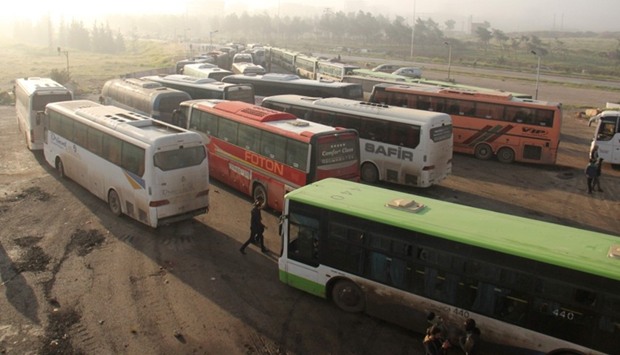 Buses carrying people from government-held Fuaa and Kafraya arrive in rebel-held Rashidin, west of the Syrian Aleppo city as part of an evacuation deal, on April 14, 2017