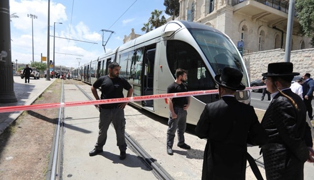 Israeli policemen block a road where the light train passes following a stabbing attack just outside Jerusalem's Old City, according to Israeli police. Reuters