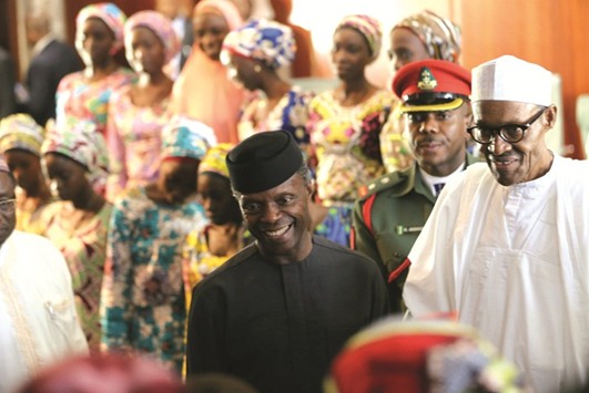 President Buhari and Vice-President Yemi Osinbajo receiving the 21 Chibok schoolgirls released by Boko Haram, in Abuja on October 19 last year.
