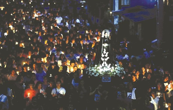 Devotees take part in a Good Friday procession in Mogpog, Marinduque, central Philippines, yesterday.