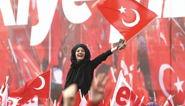 Supporters of Turkish President Recep Tayyip Erdogan wave national flags during a rally for the upcoming referendum in Konya, Turkey yesterday. The vote comes on the heels of a difficult start to the year thatu2019s seen Turkeyu2019s lira drop to record lows, its central bank take more unorthodox steps to buoy markets, and government efforts to tempt voters and kick-start a slowing economy.