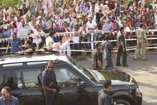 Prime Minister Narendra Modi waves to supporters during a road show in Bhubaneswar yesterday.