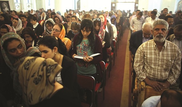 Egyptian Christians pray during the Good Friday procession at the St George church in the town of Mohalla.