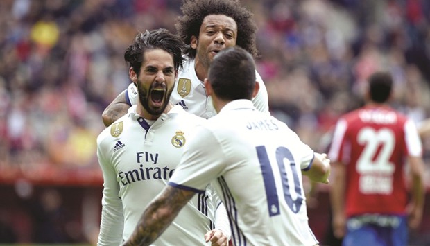 Real Madridu2019s Francisco u201cIscou201d Alarcon (L) celebrates with teammates Marcelo and James Rodriguez after scoring a goal.