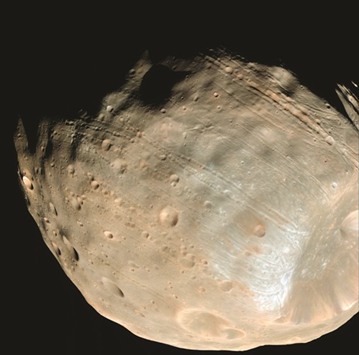 This file Nasa photo obtained on November 11, 2015 shows the long, shallow grooves lining the surface of Phobos are likely early signs of the structural failure that will ultimately destroy this moon of Mars.