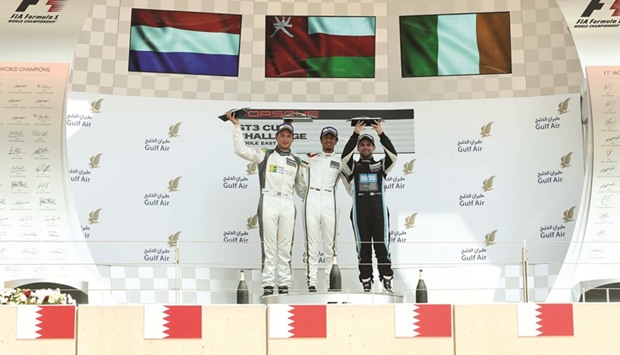 Faisal al-Zubair (C), Charlie Frijns (L) and Ryan Cullen pose on the podium of the penultimate race of Porsche GT3 Cup Challenge Middle East Season 8 at Sakhir, Bharain, yesterday.
