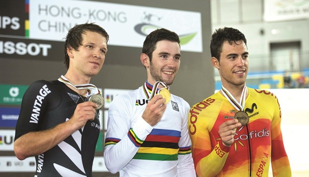 Gold medallist Franceu2019s Benjamin Thomas (C) is flanked by Silver medallist New Zealandu2019s Aaron Gate (L) and Bronze medallist Spainu2019s Albert Torres Barcelo (R) as they pose during the medal ceremony for the menu2019s Omnium at the 2017 Track Cycling World Championships in Hong Kong yesterday. (AFP)