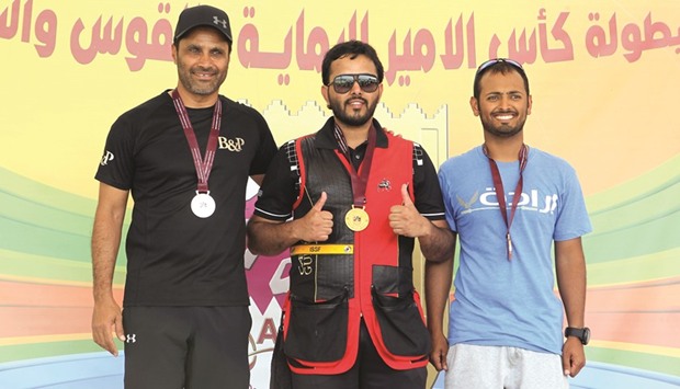 Gold winner Rashid Masoud Jaralla (C), silver winner Nasser Saleh al-Attiyah (L) and Khalid al-Muhannadi pose on the podium.