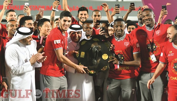 QFA Vice-President Saoud al-Mohannadi presents the QSL Falcon Shield to Lekhwiyau2019s Karim Boudiaf and Mohamed Mousa on the last day of the tournament at the Abdulla bin Khalifa Stadium yesterday. Bottom, Lekhwiya coach Djamel Belmadi celebrates with the Falcon Shield as star performer Nam Tae-Hee obliges a fan. Picture: Noushad Thekkayil