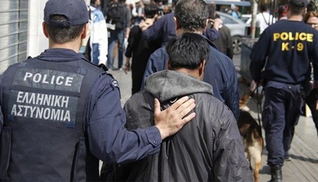 Greek police are seen with some suspected traffickers in February this year.