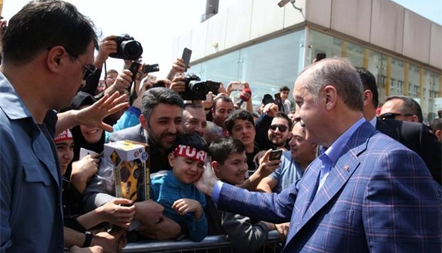 President Erdogan greets his supporters outside a polling station in Istanbul.