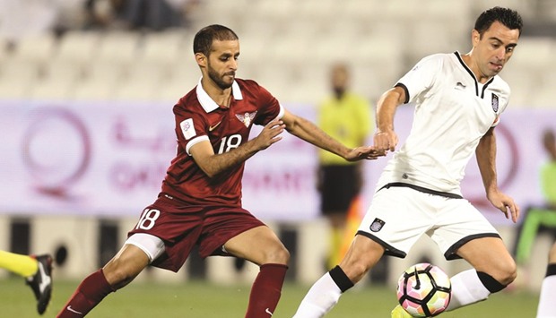 Al Sadd skipper Xavi is hassled by El Jaishu2019s Mohamed al-Yazidi during their last QSL match yesterday.