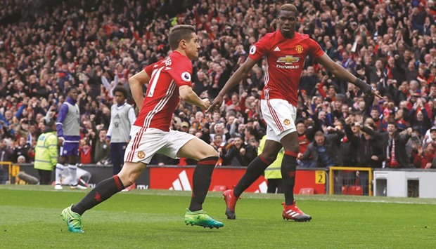 Manchester Unitedu2019s Ander Herrera celebrates scoring their second goal against Chelsea with Paul Pogba yesterday. (Reuters)