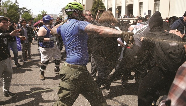 A Trump supporter runs at protesters while being pepper sprayed at a Patriots Day free speech rally in Berkeley, California.