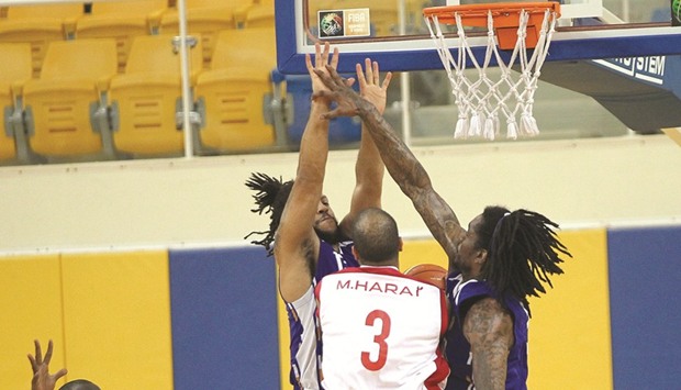 Al Khor players (in blue) defend against Al Shamalu2019s Mohamed Harat (second from right) while his teammate Saleh Elhag (left) looks on during the Emir Cup basketball match at Al Gharafa Sports Club yesterday. Elhag scored match-high 32 points, while Harat added 21 in their teamu2019s 91-69 victory. PICTURE: Othman Iraqi