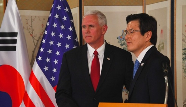 US Vice President Mike Pence (L) shakes hands with South Korea's Prime Minister and Acting President Hwang Kyo-Ahn (R)