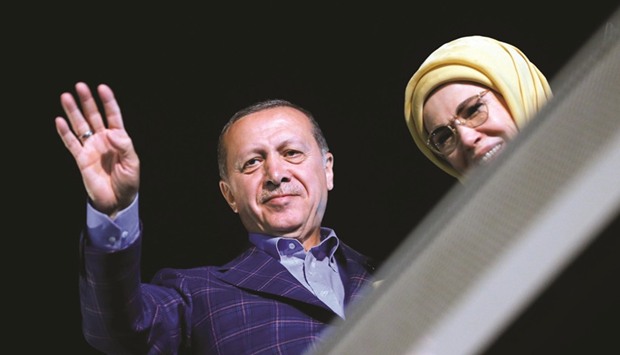 Turkish President Recep Tayyip Erdogan and his wife Emine greet supporters near Tarabya mansion in Istanbul yesterday.