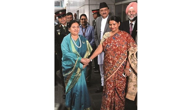 Indian Minister of State for Women and Child Development Krishna Raj, right, welcomes Nepal President Bidya Devi Bhandari on her arrival at Indira Gandhi International Airport in New Delhi yesterday.