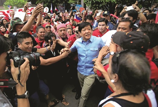 Former senator Ferdinand u201cBongbongu201d Marcos Jr and son of late former dictator Ferdinand Marcos is greeted by his supporters upon his arrival at the Supreme Court in Metro Manila yesterday.