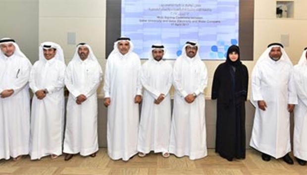 HE the Minister of Energy and Industry Dr Mohamed bin Saleh al-Sada and senior officials from QU and QEWC at the MoU signing ceremony on Monday.