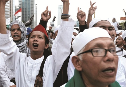 Members of the Islamic Defenders Front (FPI) shout slogans during a protest against Jakarta governor Basuki Tjahaja Purnama in Jakarta.
