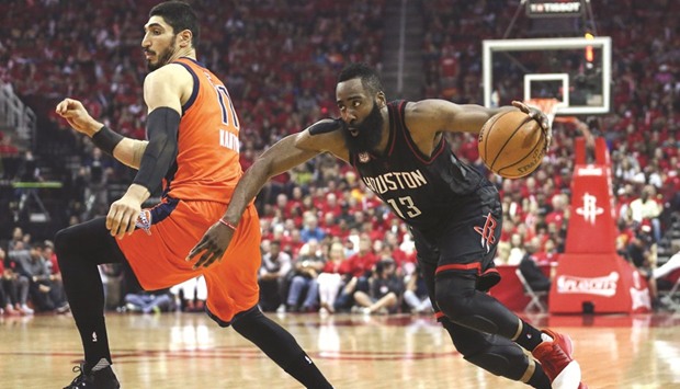 Houston Rockets guard James Harden (13) dribbles the ball around Oklahoma City Thunder center Enes Kanter (11) during the third quarter of their game on Sunday.