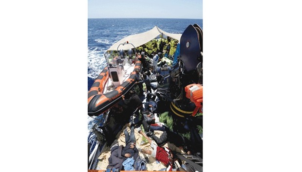 Migrants rest on the Malta-based NGO Migrant Offshore Aid Station (MOAS) ship Phoenix after being rescued in the central Mediterranean off the Libyan coast.