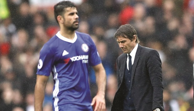 Chelsea manager Antonio Conte (R) and Diego Costa look dejected after their loss to Manchester United.