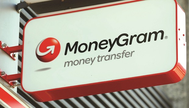 A MoneyGram logo is seen outside a bank in Vienna, Austria. Ant Financial, the finance affiliate of Alibaba Group, increased its bid to $18 per share in cash from $13.25 to value MoneyGram at around $1.2bn.
