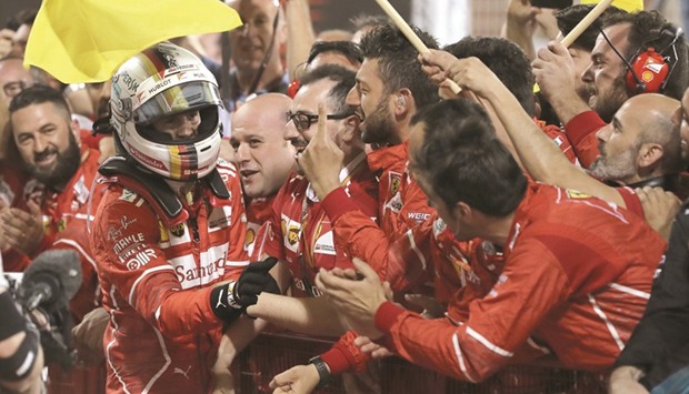 Ferrariu2019s German driver Sebastian Vettel celebrates with his team after winning the Bahrain Grand Prix at the Sakhir circuit on Sunday. (AFP)