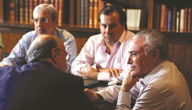 Brazilu2019s President Michel Temer (R) and Finance Minister Henrique Meireles attend a meeting of the Pension Reform Commission at the Alvorada Palace in Brasilia.