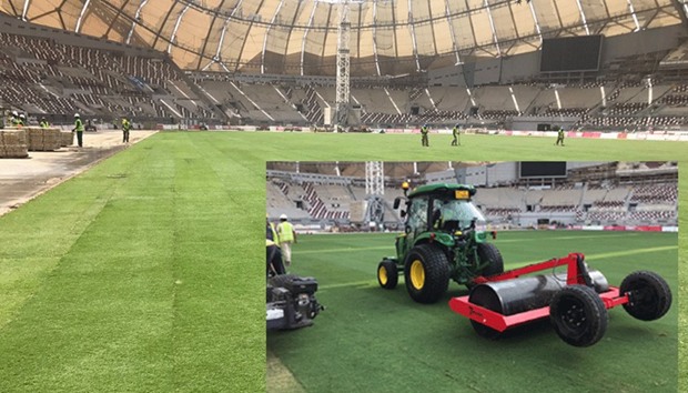 The newly-laid turf at the Khalifa Stadium which was completed in just 13-and-a-half hours. Inset: Turf-laying work in progress at the Khalifa International Stadium.