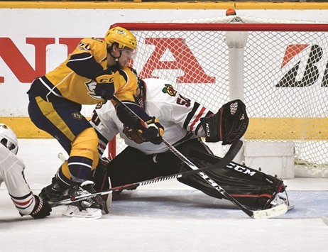 Nashville Predatorsu2019 Kevin Fiala (left) scores the game-winning goal past Chicago Blackhawks goalie Corey Crawford in game three of the first round of the 2017 Stanley Cup Playoffs in Nashville, Tennessee, on Monday. (USA TODAY Sports)